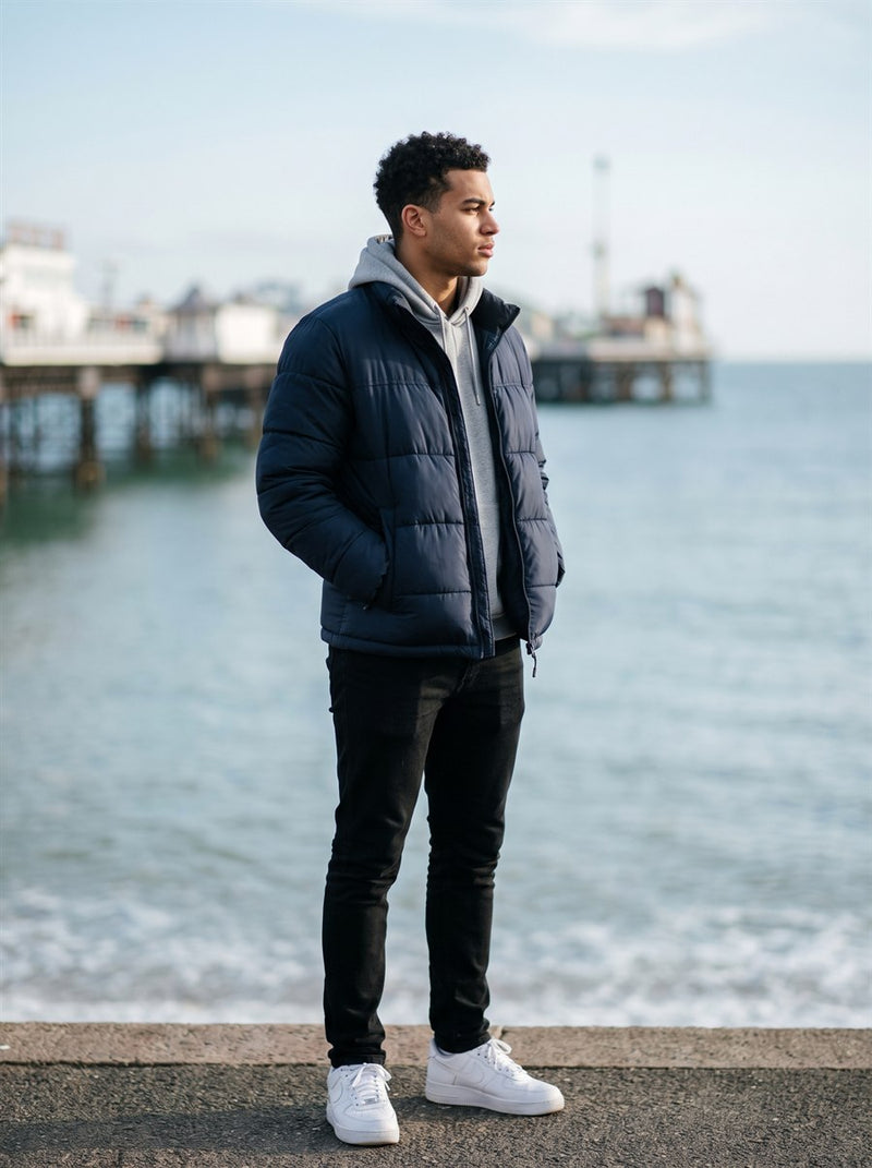Customer in a navy puffer jacket on Brighton seafront