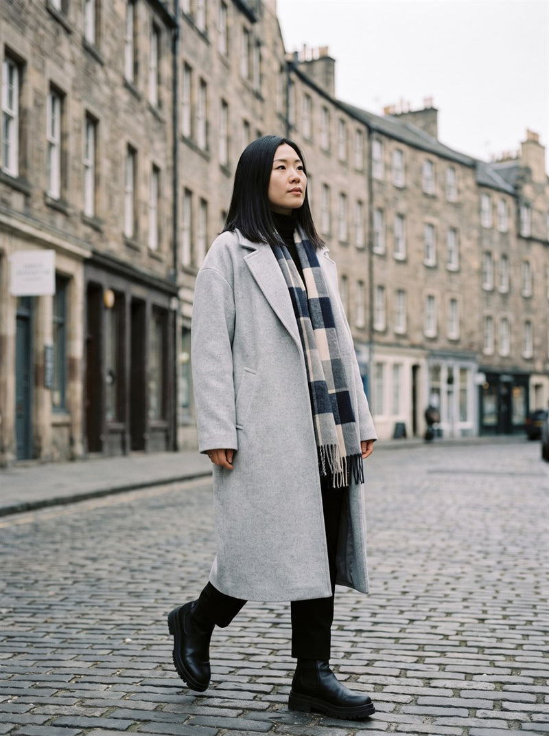 Customer in a grey wool coat in Edinburgh old town