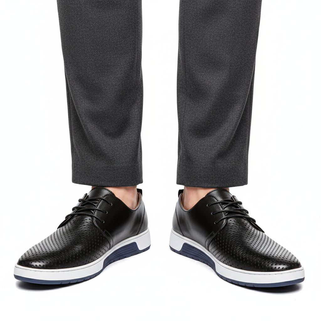 Men's perforated lace up derby shoes in black, worn with tailored trousers